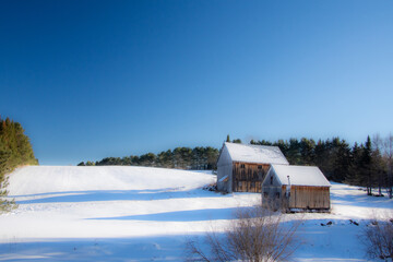 Old barn in a field during Quebec winter in Canada