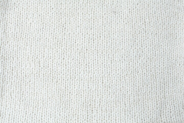 Fototapeta na wymiar Natural knitted fabric, hand knit, plain knitting, white sheeps' wool