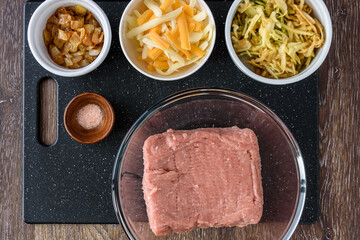 Ingredients for turkey meatballs, ground turkey, cheddar cheese, shredded apple, caramelized onion, and Himalayan salt
