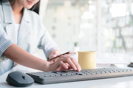 Closeup image of woman hand typing on computer keyboard.