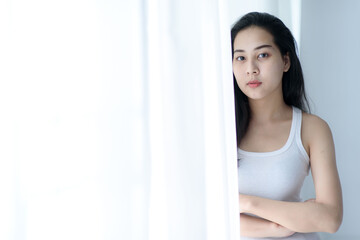 Portrait of young woman in a bed room