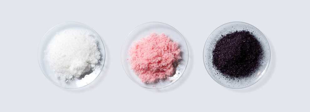 Cosmetic chemicals ingredient on laboratory table. Cetyl esters wax, Pink flake chemicals, Potassium permanganate. (Top View)