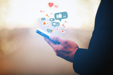 A close up view of a businessman using a smartphone to communicate via social media at night in the city.