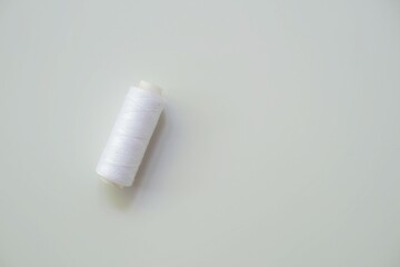Spool of white thread for sewing