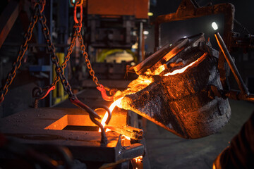 Hard work in foundry. Melting iron and casting.