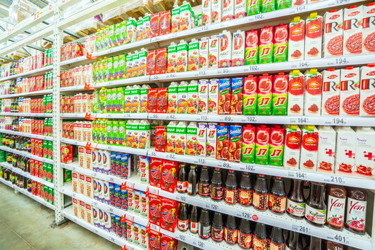 Russia Samara March 2019: A large selection of fruit juices in the supermarket. Text in Russian: kind, pomegranate, discount, darling, My family, orchard