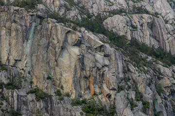 Fototapeta na wymiar Rock faces along the fjord cliffs and seaside walls of Noway