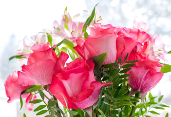 Bouquet of fresh pink roses and alstroemeria on a white background closeup