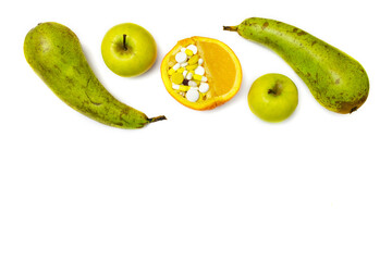 Fruits instead of drugs. Proper nutrition and vitamins for prevention of diseases. Orange with lot of pills in half and apples, pears around. Flat lay. Top view. Copy space. We are what we eat