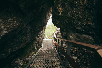 stairs pass through the rock, the descent up the stairs through a hole in the rock, the iron...