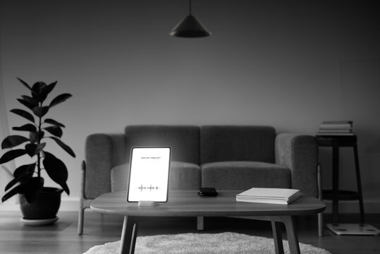 Digital tablet screen with smart home controller on a wooden table