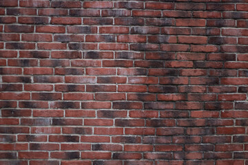 Brick texture from old stone. 18th century brick wall. Old burnt brick masonry. Shooting details close-up. Aged red clay color. Rectangular blocks laid out in rows and held together with cement.