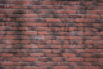 Brick texture from old stone. 18th century brick wall. Old burnt brick masonry. Shooting details close-up. Aged red clay color. Rectangular blocks laid out in rows and held together with cement.