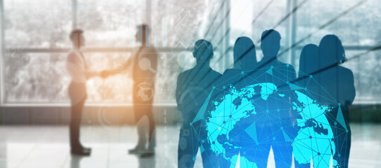 Silhouette of business partners shaking hands in office