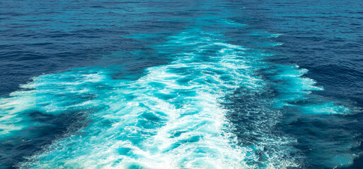 Rough deep turquoise and dark blue pacific sea with white foam texture and background