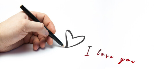 The hand writes on a blank sheet I love you. Heart. Happy Valentine's Day.