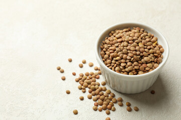 Bowl with legumes on white textured background