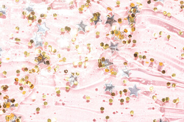 Obraz na płótnie Canvas gold glitter and silver star confetti in a transparent gel texture