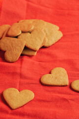 Amount of Valentine's day cookies for background isolated on red. Valentine's day and love concept. Selective focus. Vertical