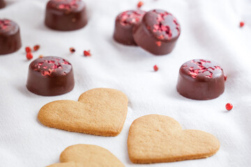 Close up view of Valentine's Day cookies with chocolates on the background. Selective focus. Valentine's Day background