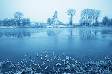 winter landscape church on the banks of the freezing river in vologda, christianity baptism russia...