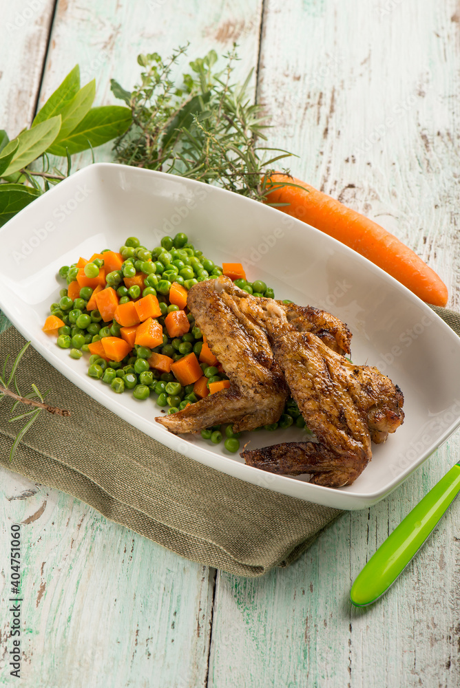 Canvas Prints chickens wings with carrots and green peas salad