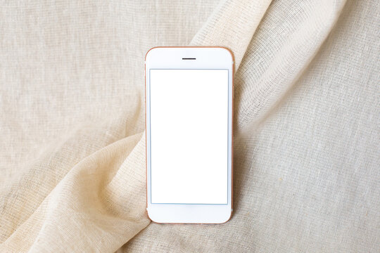 Mobile Phone On Beige Natural Cotton Fabric Background. Styled Stock Mock Up