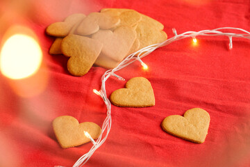 Valentine's day cinnamon cookies background isolated on red with ethereal lights. Valentine's day and love concept. Selective focus