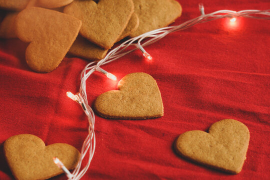 Valentine's day cookies background isolated on red with ethereal lights. Valentine's day and love concept. Selective focus. Dull edition