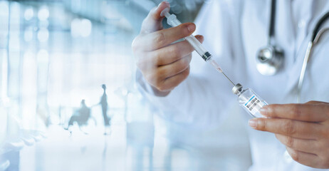 Doctor hold syringe and vial containing covid-19 coronavirus vaccine ready for injection. Laboratory accelerating develop vaccine and medicine for covid-19 pandemic. Healthcare and medical technology.