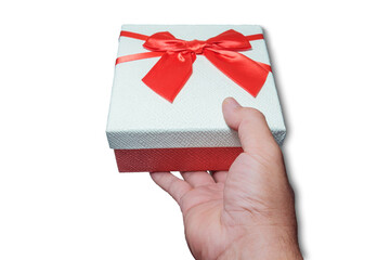 Hand holding a red gift box, white lid, red bow tie on a white background isoleted with clipping path.