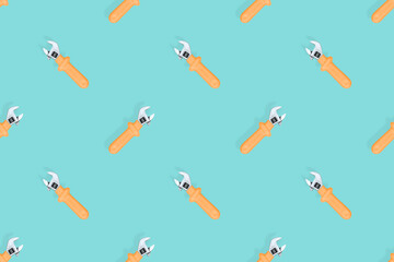 Adjustable metal wrench seamless pattern. Adjustable metal wrench on an aquamarine background.