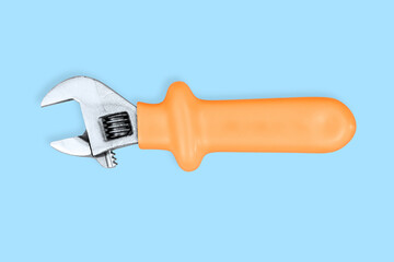 Adjustable metal wrench with a rubberized handle on a blue background.