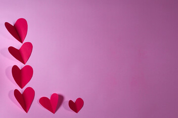 RED PAPER HEARTS ON PINK BACKGROUND