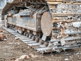 Close up detail with chain tracks of a bulldozer on a demolition site