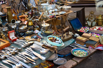 Different antiques on flea market - vintage silver cultery - spoons, knifes, forks and other...