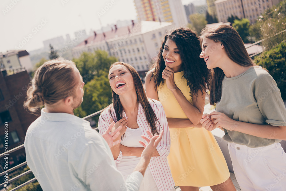 Poster Photo of young attractive friends speak talk communicate laugh humor joke fun funny enjoy free time outside