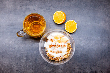 Healthyfood, granola with yogurt, pineaple and apple, tea with lemon. Heathy breakfast