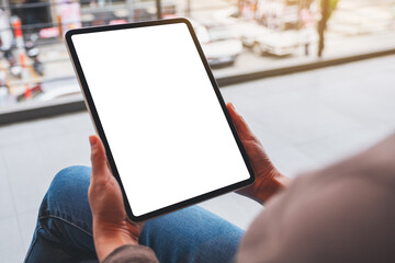 Mockup image of a woman holding digital tablet with blank white desktop screen