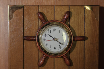 Wall clock in the shape of naval helm.