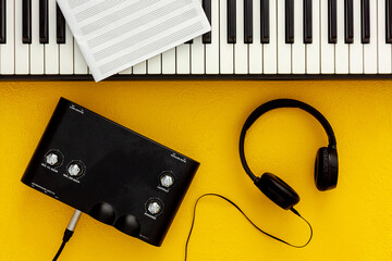 Musician work set with synthesizer; note and headphones