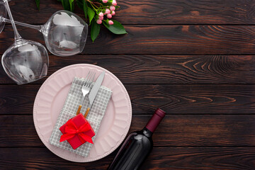 Valentine's day table setting with plate, wine and glasses