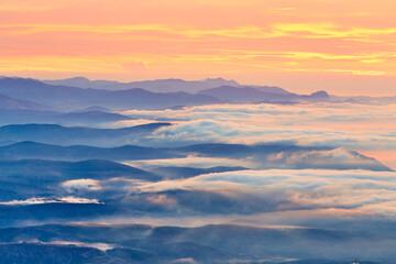 sunrise on the coast in clouds and mountains