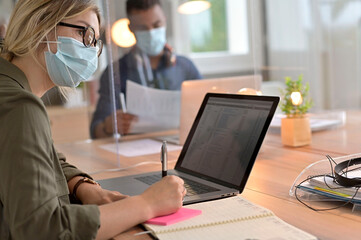Multiracial staff at work in cowork office - Young people wearing surgical mask for coronavirus