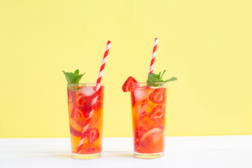Strawberry lemonade with ice cubes, lemon and mint.