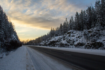 Fototapeta na wymiar Wonderful winter track in Siberia between the rocks at dawn. Siberian track at dawn