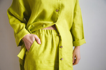 Girl in pajamas in a yellow shirt made of linen, beautiful home clothes. Cozy bathrobe. Natural...