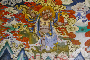 Obraz na płótnie Canvas Colorful traditional wall painting of wrathful deity riding green horse in Gangtey gompa or monastery, Phobjikha valley, Bhutan