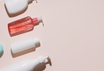 Cosmetic products for body and hair care on a beige background. Copy space