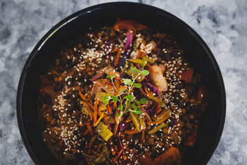 healthy plant-based food, vegan nourish bowl with mexican beans and mixed veggies coleslaw topped with sesame seeds